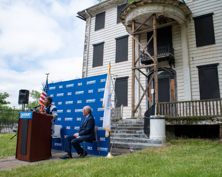 interim president jenkins-scott and ed markey present in front of the former dudley house, which will become the center for economic and social justice at RCC